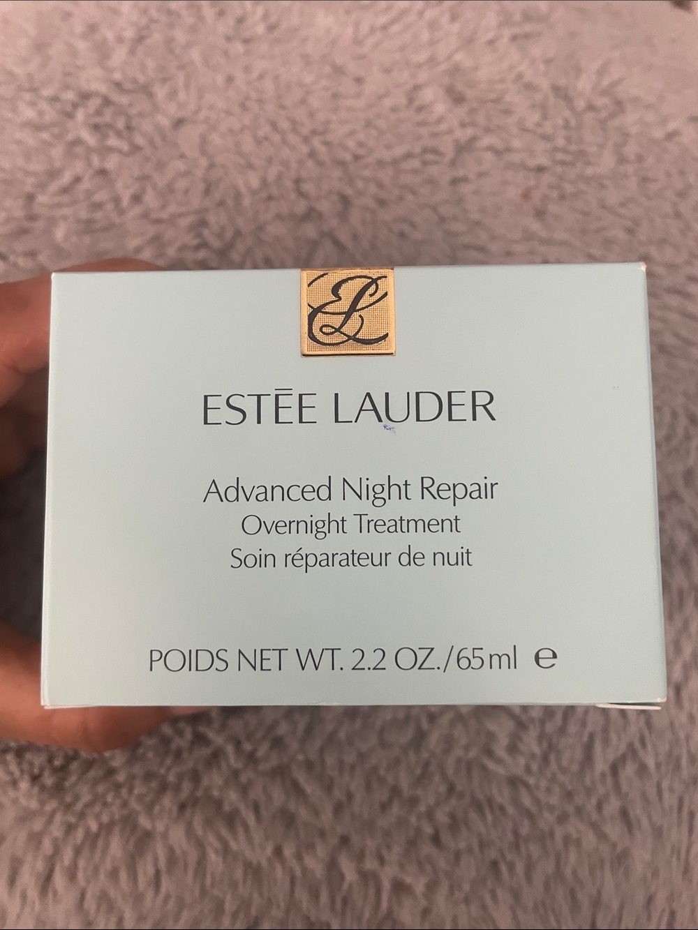 Estee Lauder teal box with brown and gold jar